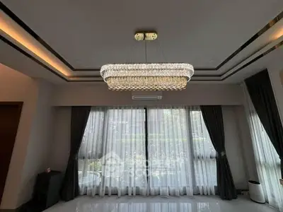 Luxurious living room with elegant chandelier and large windows