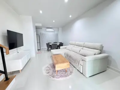 Spacious modern living room with sleek furniture and natural lighting
