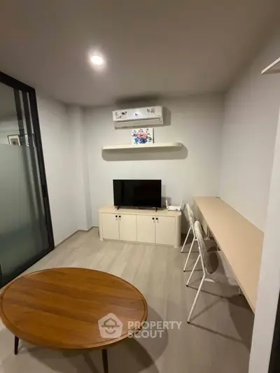 Modern living room with sleek furniture and air conditioning, perfect for cozy living.