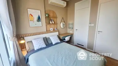 Cozy bedroom with a comfortable double bed, tasteful wall art, and modern lighting, perfect for relaxation and tranquility in a well-maintained home.