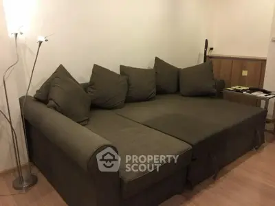 Cozy living room with modern sectional sofa and stylish floor lamp