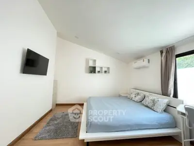 Modern bedroom with minimalist decor, featuring a wall-mounted TV and air conditioning.