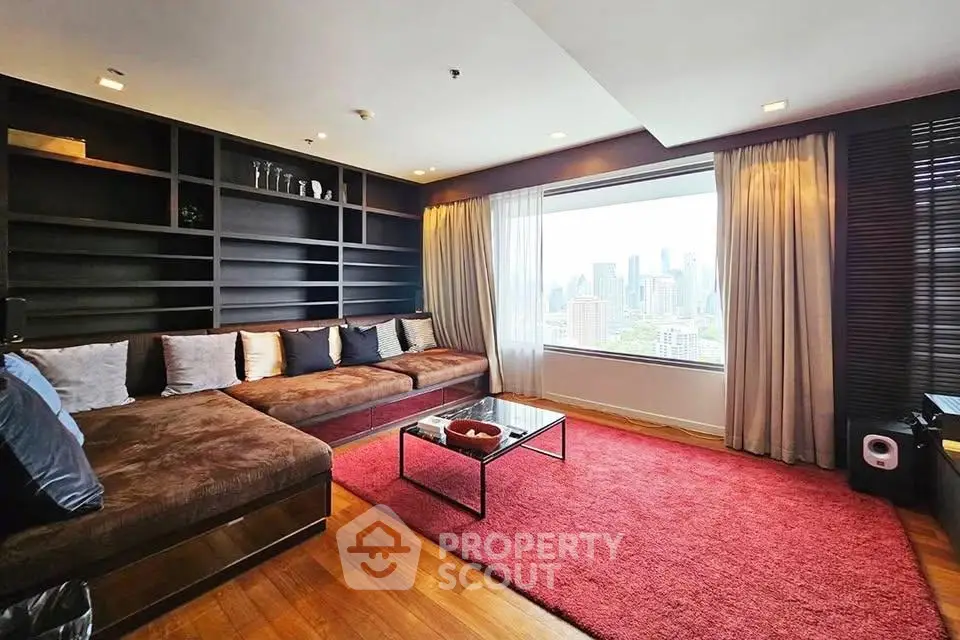 Luxurious living room with city view, featuring plush seating and elegant decor.