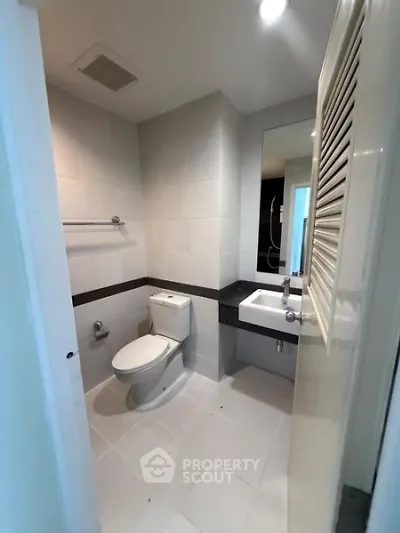 Modern bathroom with sleek white tiles and contemporary fixtures