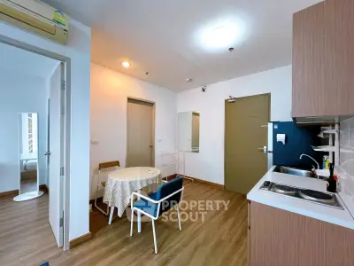 Charming apartment with cozy kitchen and dining area, featuring modern decor and wooden flooring.