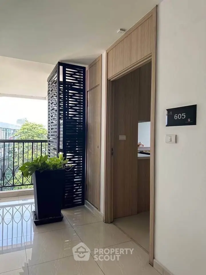 Modern apartment entrance with stylish decor and balcony view