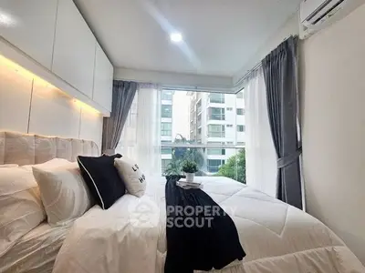 Modern bedroom with large windows and elegant decor in urban apartment