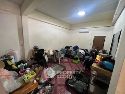 Cluttered bedroom with basic furnishings and personal items, showcasing potential for renovation.