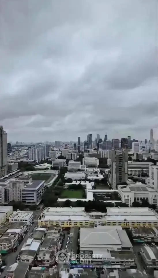 Stunning cityscape view showcasing urban skyline and architecture under a cloudy sky.
