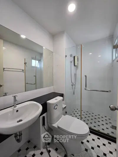 Modern bathroom with sleek fixtures and glass shower enclosure