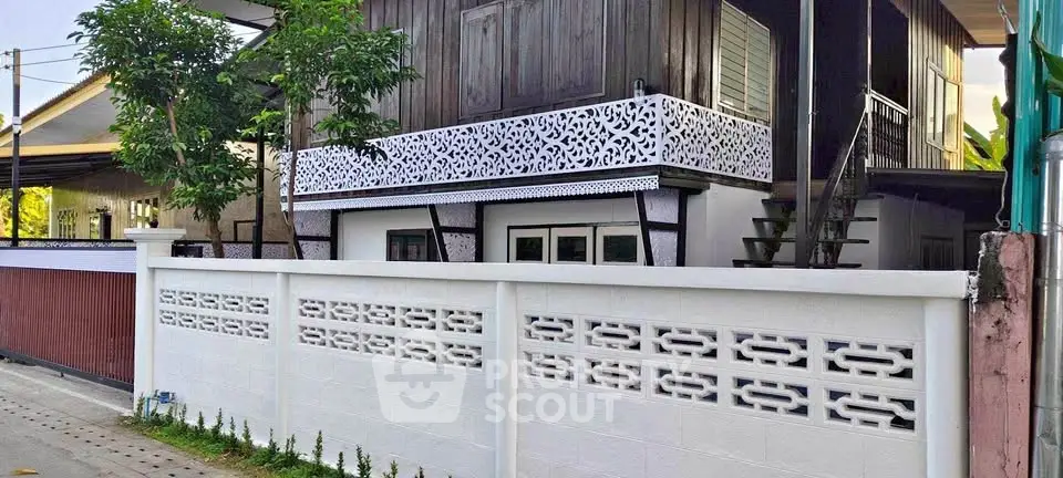 Charming two-story home with decorative balcony and modern exterior design.