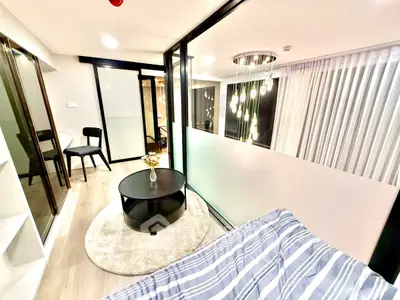 Modern living room with stylish decor and glass partitions in a contemporary apartment.