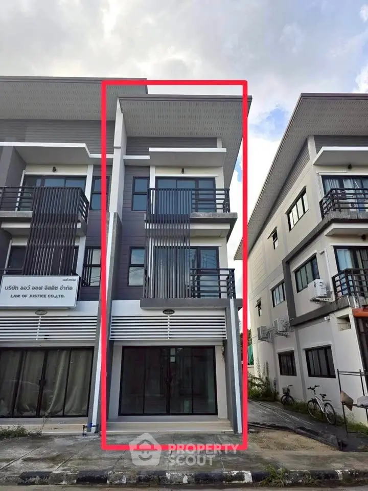 Modern townhouse exterior with sleek design and multiple balconies, perfect for urban living.