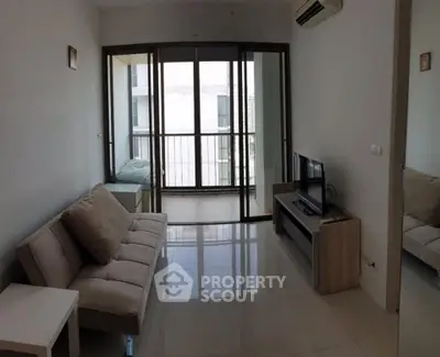 Modern living room with sleek furniture and large windows offering natural light.