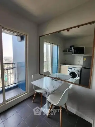 Modern kitchen with marble dining table, washing machine, and balcony view.