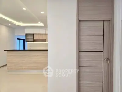 Modern open kitchen with sleek cabinetry and recessed lighting in a contemporary apartment.