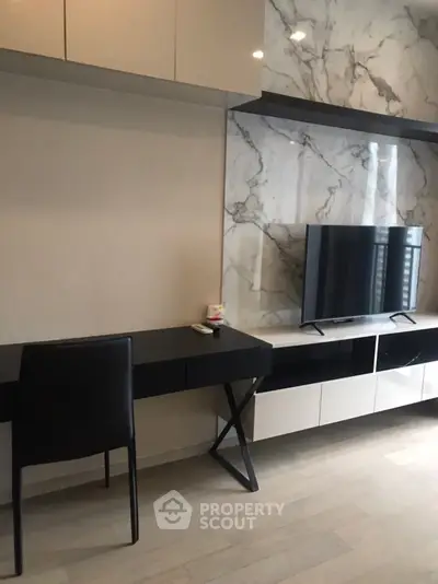 Modern living room with sleek TV unit and marble accent wall