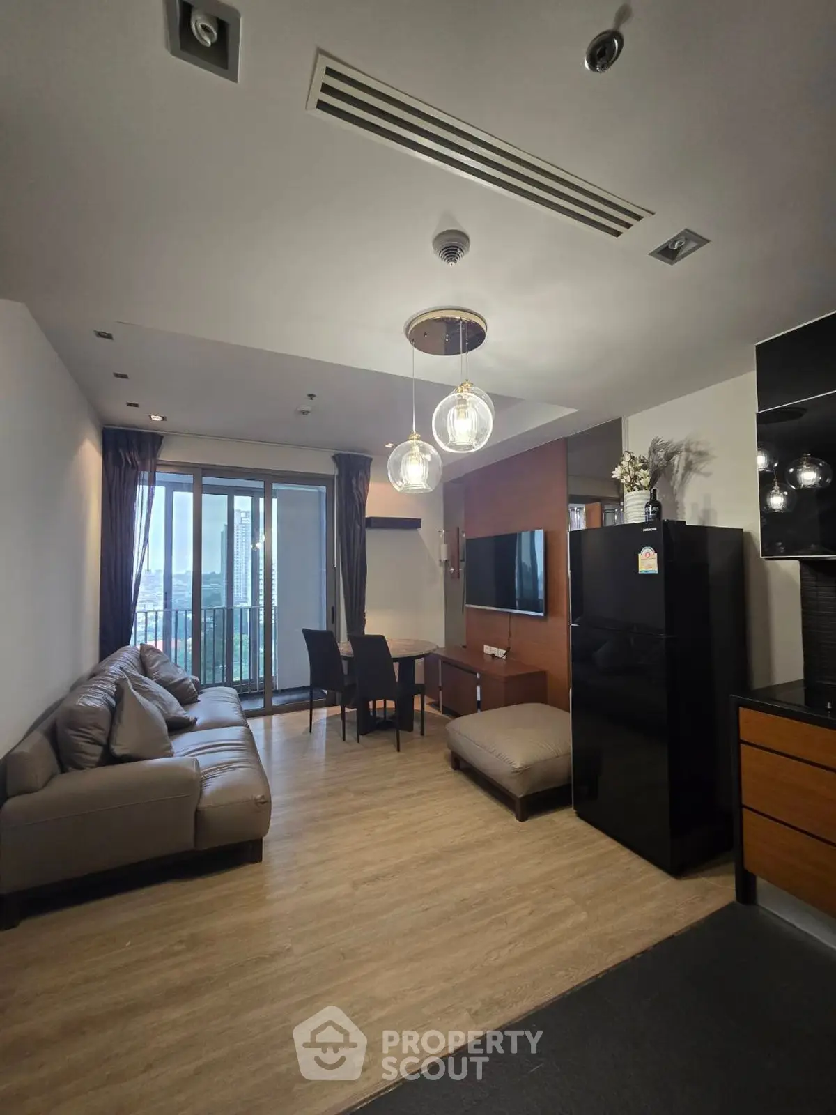 Modern living room with stylish decor and city view balcony