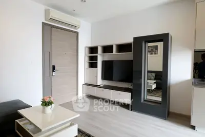 Modern living room with sleek furniture and entertainment center, featuring a stylish air conditioner and elegant decor.