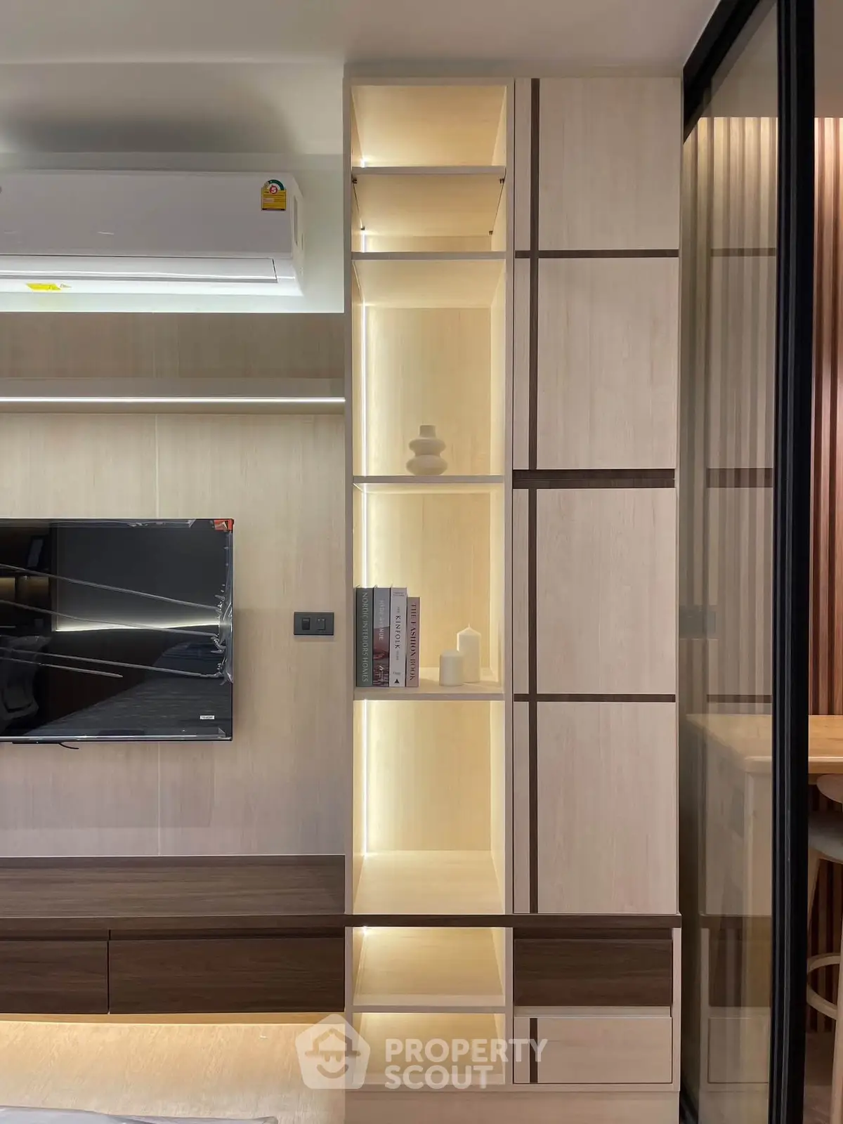 Modern living room with sleek built-in shelving and wall-mounted TV
