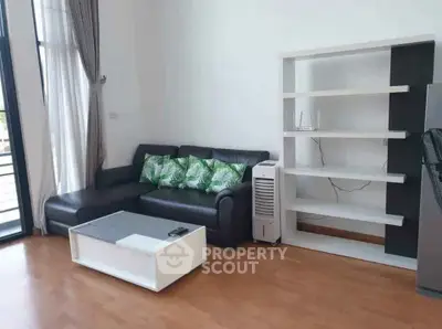 Modern living room with stylish black sofa and sleek white shelving unit