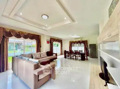 Spacious open-plan living and dining area with modern furnishings and large windows for natural light.