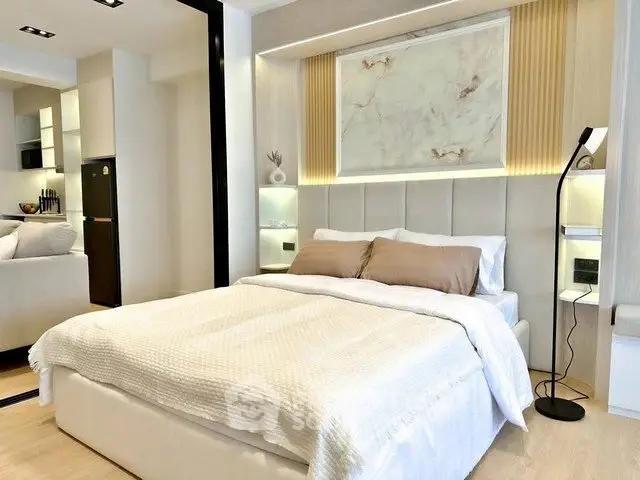 Modern bedroom with elegant decor and cozy ambiance in a stylish apartment.