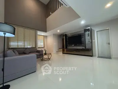 Spacious modern living room with high ceiling and elegant decor