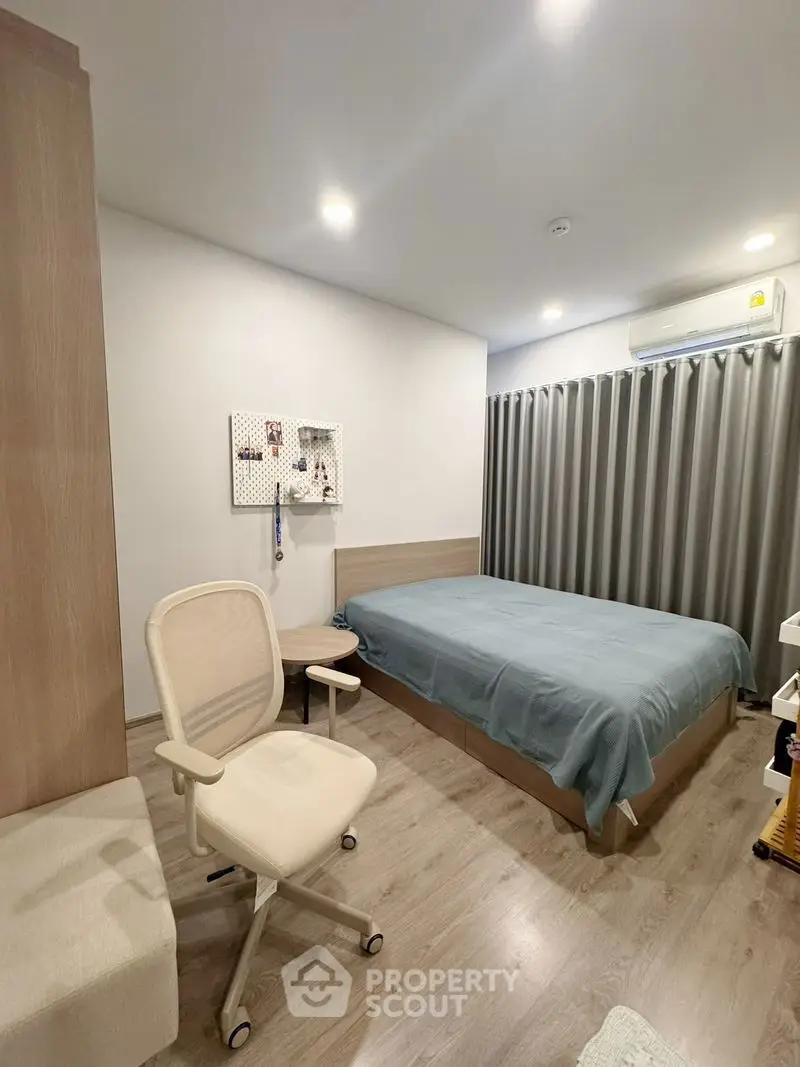 Modern bedroom with cozy decor and stylish furniture, perfect for relaxation and comfort.