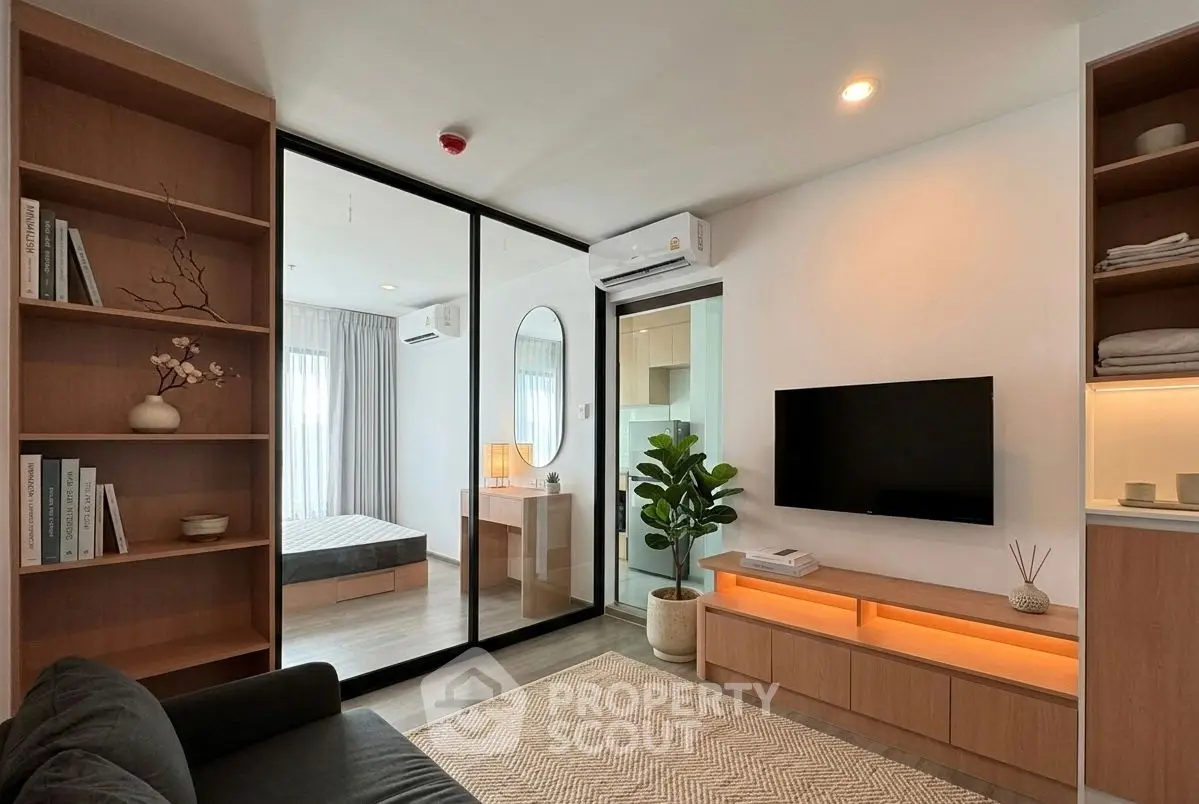 Modern living room with glass partition, cozy decor, and natural light