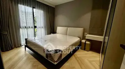 Modern bedroom with large window and stylish decor