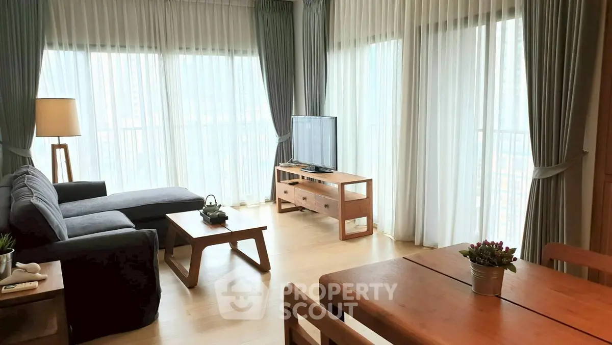Spacious living room with modern furniture and large windows for natural light.