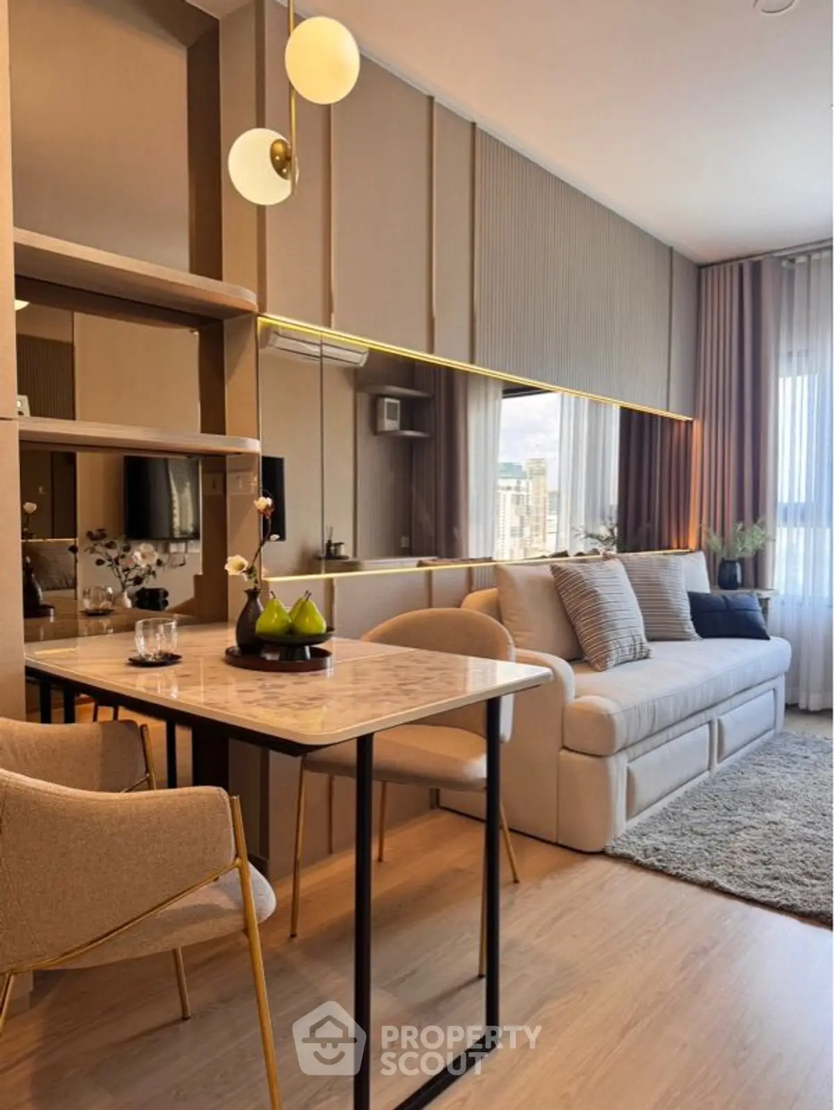 Modern living room with elegant decor and large mirror wall