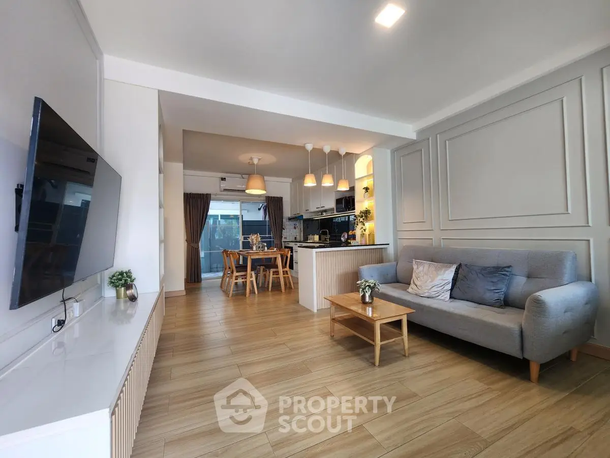 Spacious modern living room with open kitchen and stylish decor