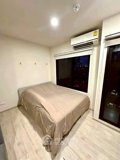 Modern bedroom with large window and air conditioning in urban apartment