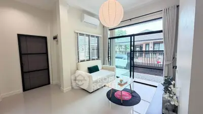 Modern living room with large window and stylish decor in a contemporary home.