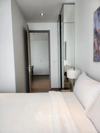 Modern bedroom with white bedding and elegant decor