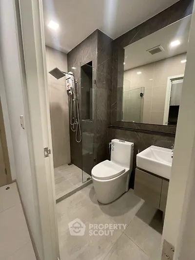 Modern bathroom with sleek design, glass shower, and contemporary fixtures.