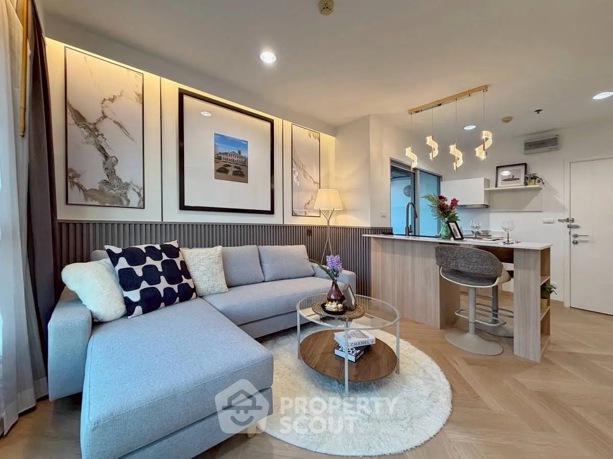 Stylish modern living room with cozy sectional sofa and chic open kitchen layout.