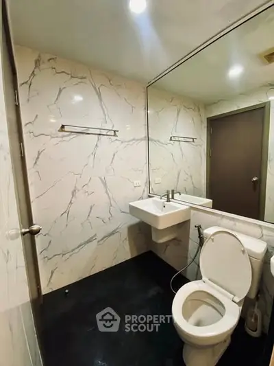 Modern bathroom with marble walls and sleek fixtures