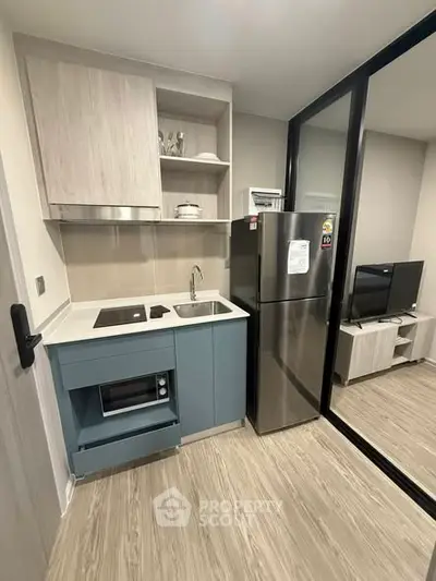 Modern compact kitchen with sleek appliances and stylish cabinetry