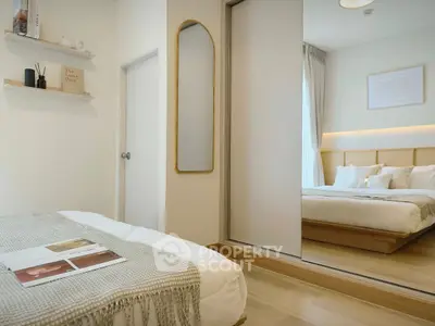 Modern bedroom with mirrored closet and cozy decor