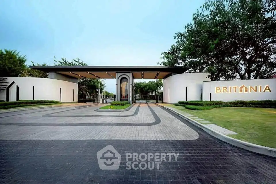 Luxurious modern building entrance with sleek design and lush greenery at Britannia.