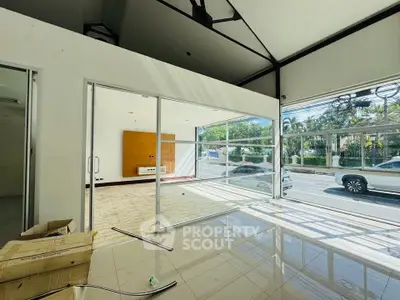 Spacious commercial space with large windows and street view, ideal for retail or office use.
