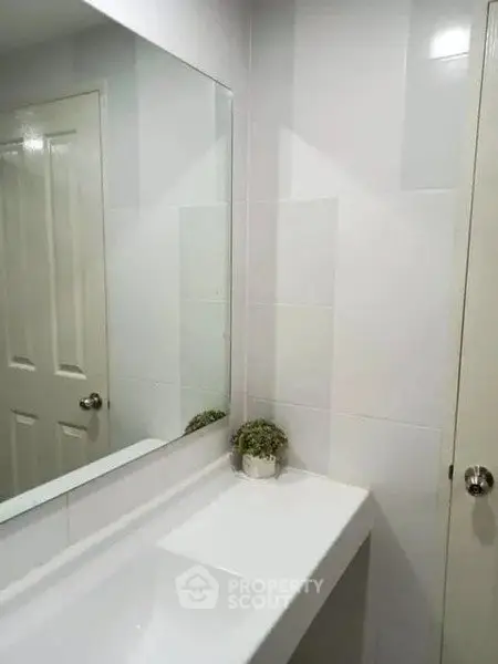 Modern bathroom with sleek white tiles and minimalist decor