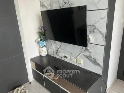 Modern living room with wall-mounted TV and sleek storage unit