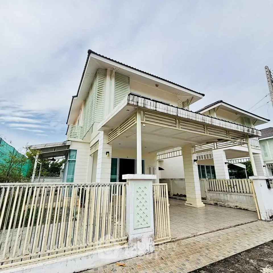Charming two-story house with spacious carport and modern design in a serene neighborhood.