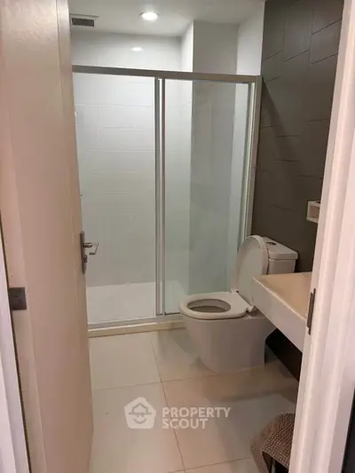 Modern bathroom with sleek shower enclosure and contemporary fixtures.