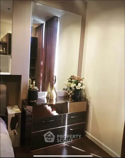 Elegant bedroom corner with modern dresser and decorative mirror