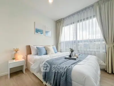 Bright and cozy bedroom with large window and elegant decor